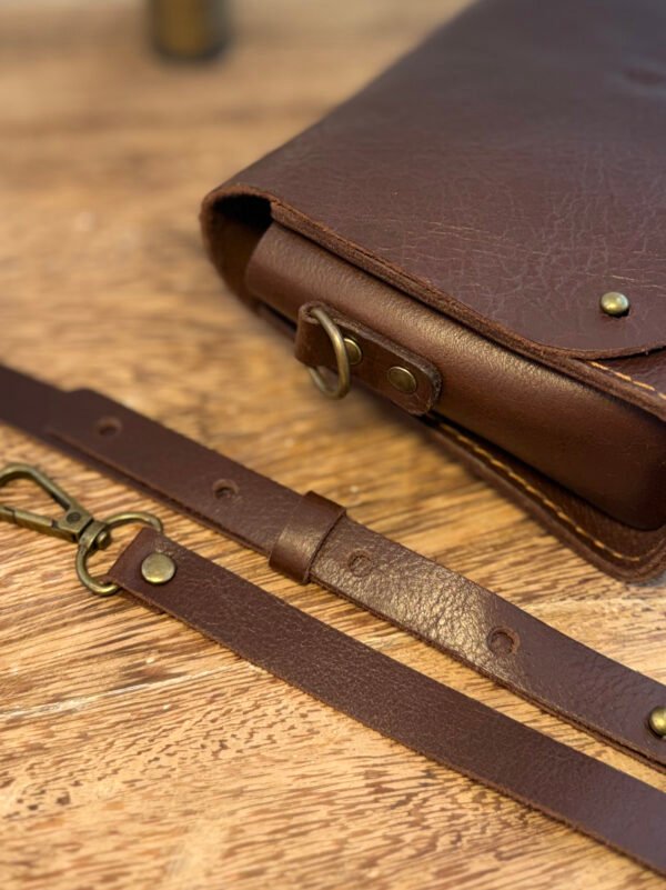 Detalhe da costura e alça da bolsa Parruá em couro legítimo